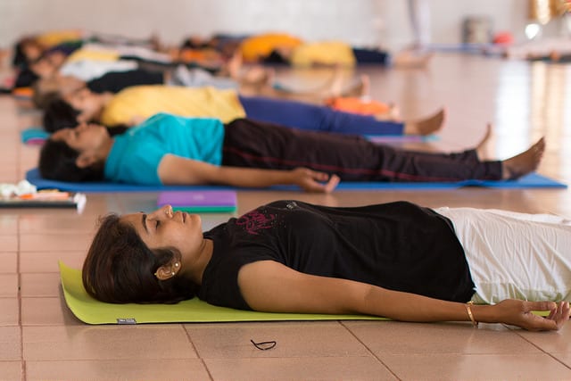 savasana, deep relaxation - a class lying still on their backs on mats.