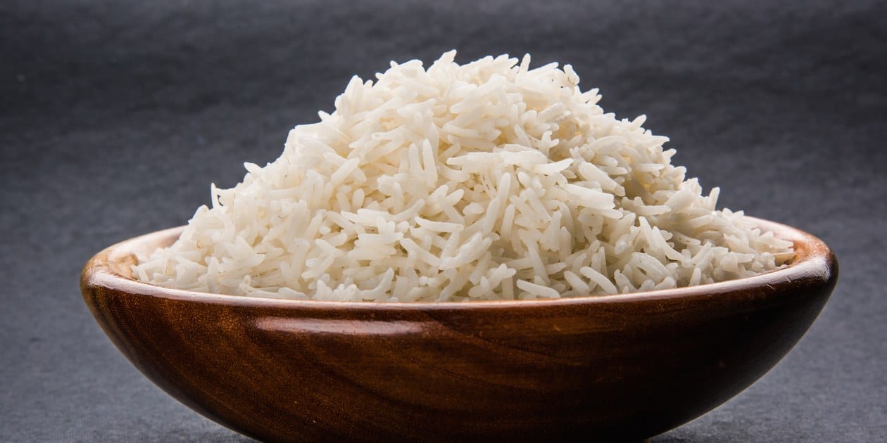 freshly cooked rice - a wooden bowl heaped with plain steamed rice.
