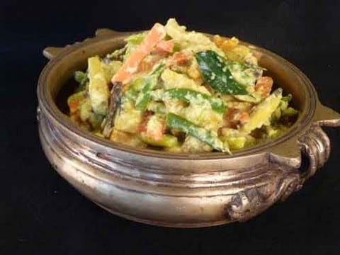 mixed vegetables - a brass pot of vegetables in a light coconut gravy.