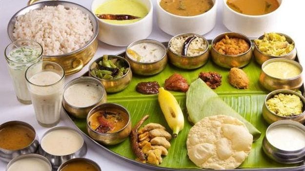 food for the soul - a full vegetarian spread served on a banana leaf with rice, curries and papad.