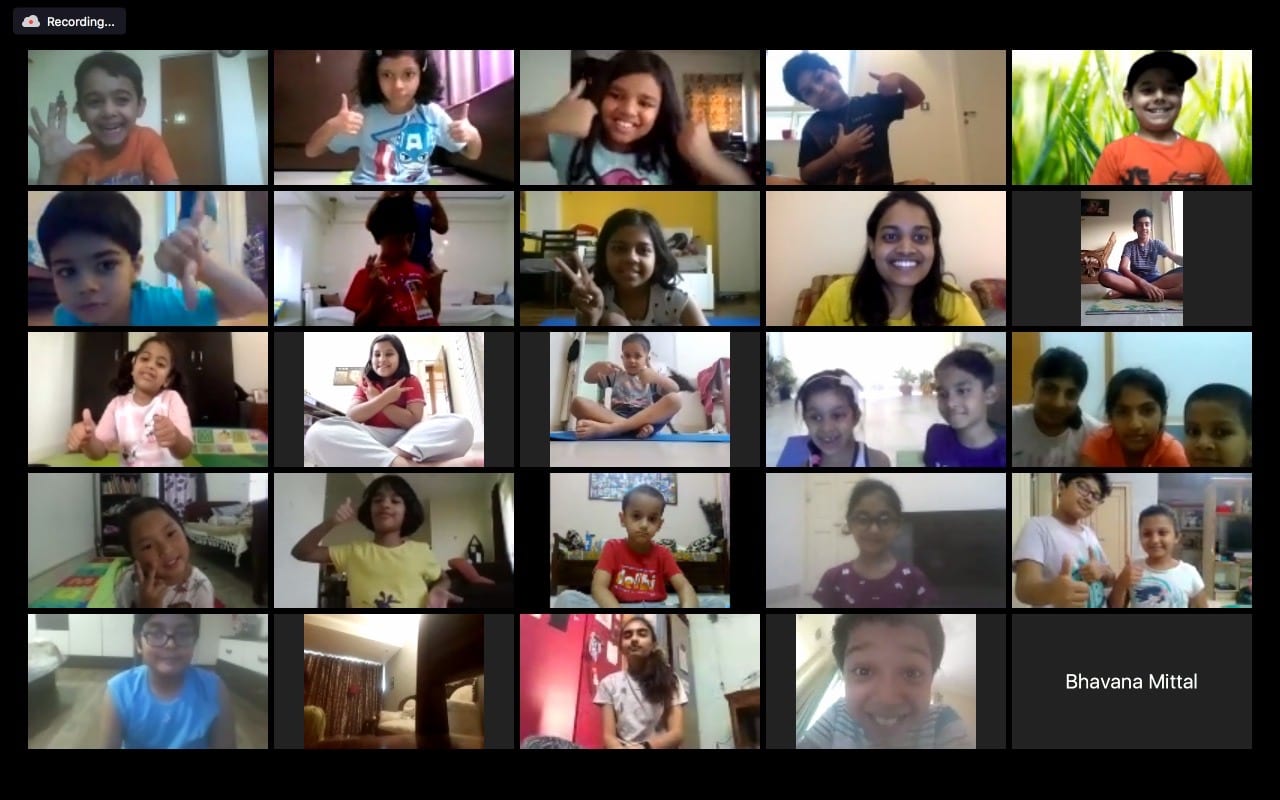 A Zoom gallery of children in a class, each one in their own room at home.