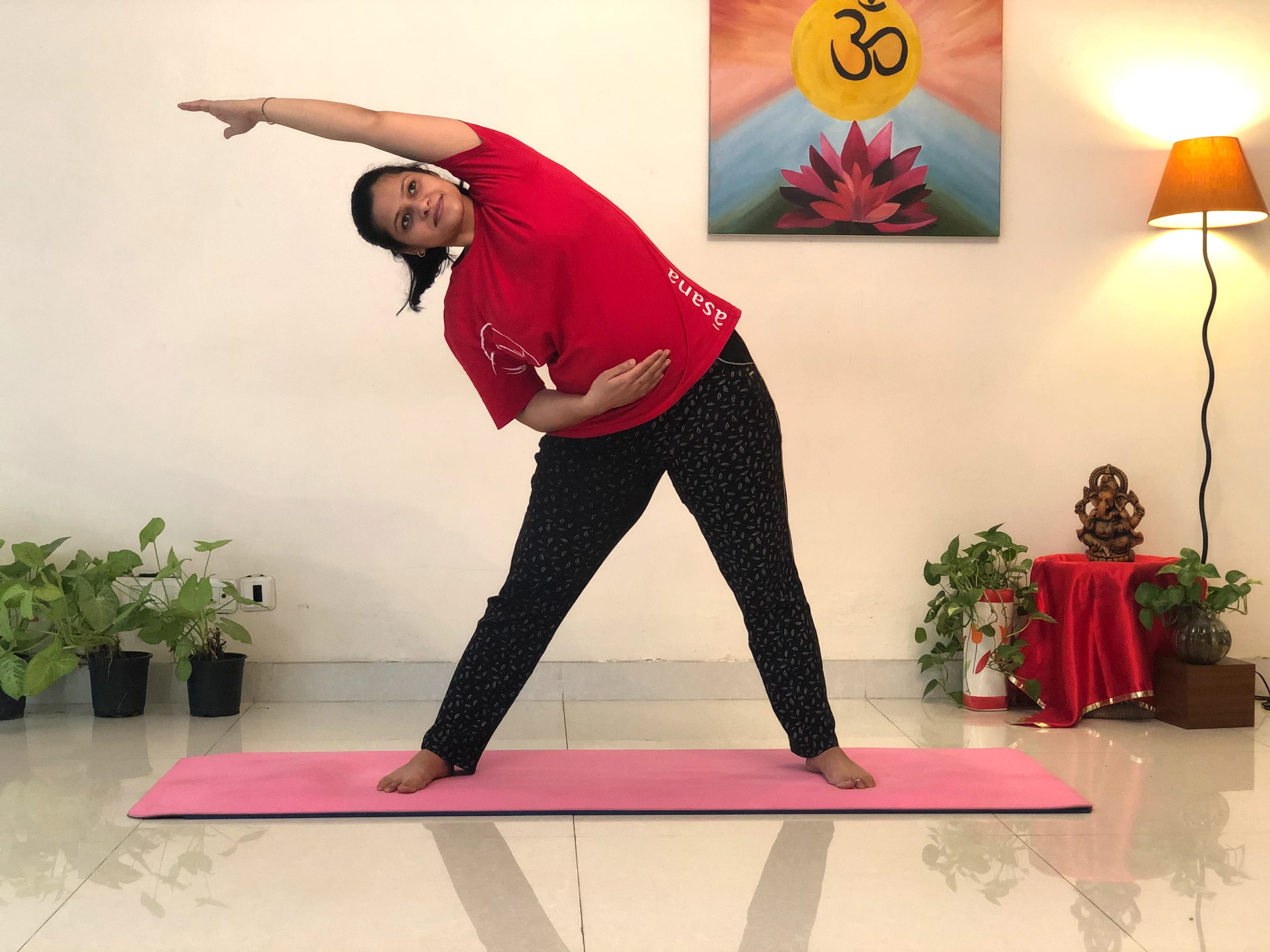 Priti in a standing side stretch at Sivananda Yoga Centre Gurgaon