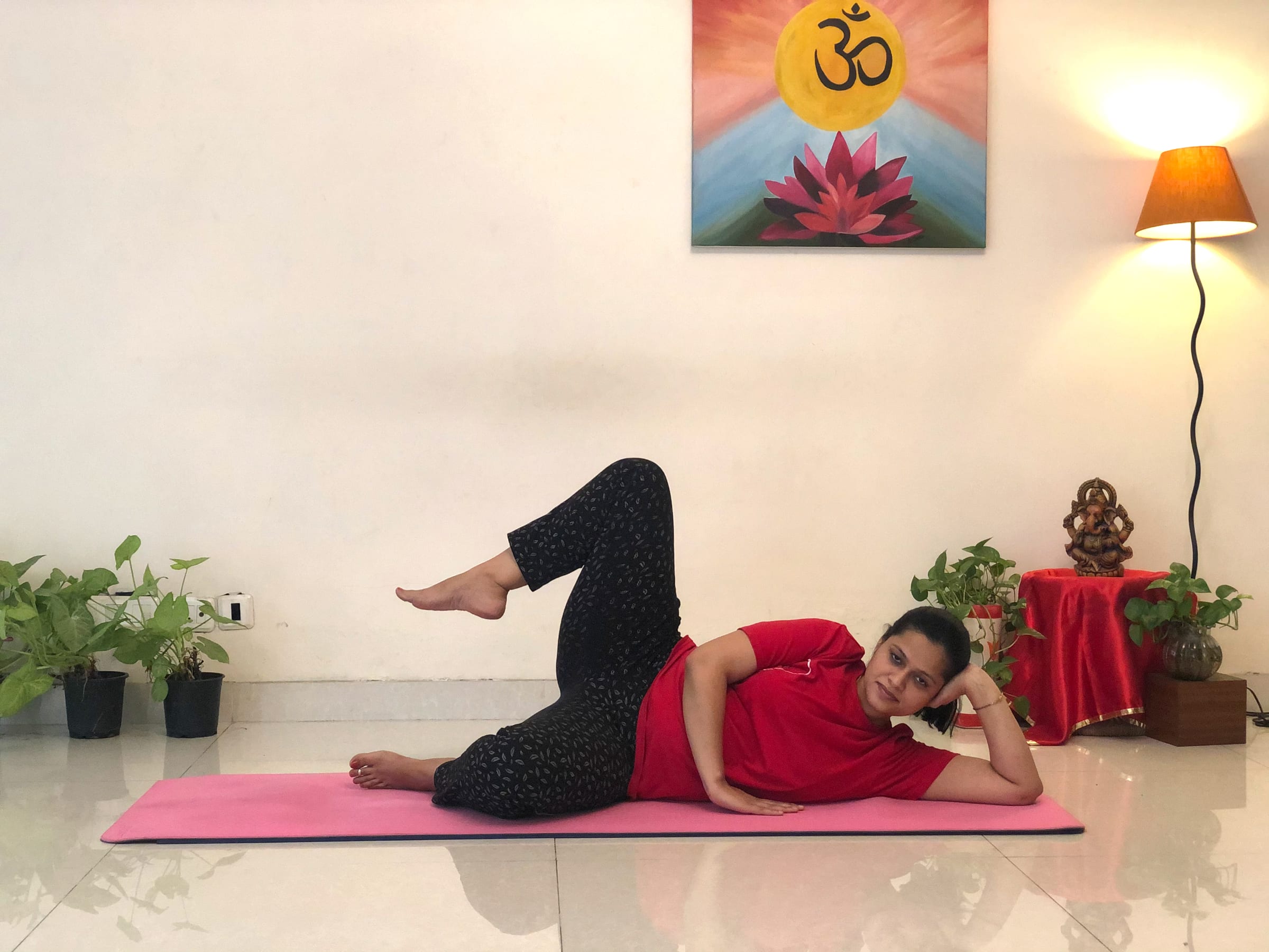 Priti in a side-lying prenatal yoga posture at Sivananda Yoga Centre Gurgaon
